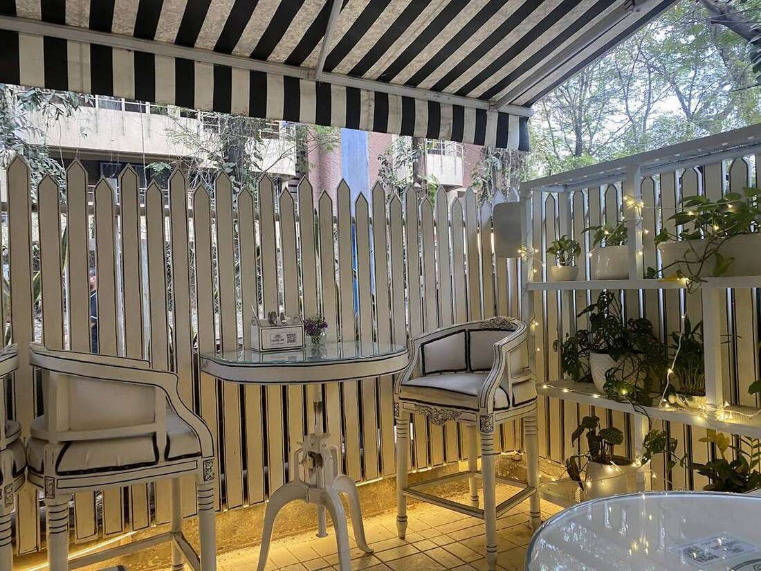 The terrace under the striped awning at night